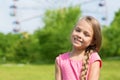 Girl seven years at an amusement park Royalty Free Stock Photo