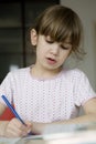 Girl seven years old doing homework Royalty Free Stock Photo