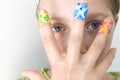 Girl with several colorful bandages