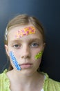 Girl with several colorful bandages Royalty Free Stock Photo