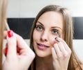 Girl shaping eyebrows with tweezer Royalty Free Stock Photo