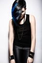 Girl with shaved head and blue hair in art gothic style with gothic accessories. Royalty Free Stock Photo