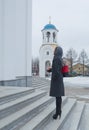 Baptized standing in front of Orthodox Church beautiful girl in a headscarf