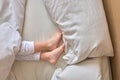 Girl between the sheets with her feet uncovered Royalty Free Stock Photo