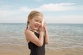 Girl with shell listening to the sea