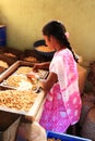 Girl shelling cashew nuts