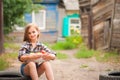 Girl in shirt and shorts with a basket of fruit. Girl farmer with apples and grapes. Concept of ecological food, person Royalty Free Stock Photo