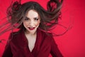 Girl in shock on pink background. Young beautiful woman with hair up.