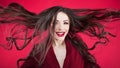 Girl in shock on pink background. Young beautiful woman with hair up.