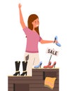 A girl with a shoe is raising her hand. Shopper in a footwear shop. Woman on sale in the store