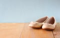 Girl shoes over wooden deck floor Royalty Free Stock Photo