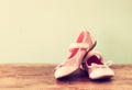 Girl shoes over wooden deck floor. Royalty Free Stock Photo