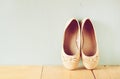 Girl shoes over wooden deck floor. filtered image Royalty Free Stock Photo