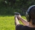 Girl shooting with a gun Royalty Free Stock Photo