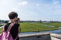 Girl is shooting Wide panorama of Zaanse Schans Windmills. Peacefull countryside scene in Netherlands