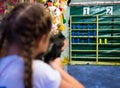 The girl shoots from an pneumatic machine in the prize dash