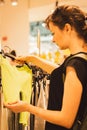 Girl in the shop mall. Shopping concept. Woman looking for casual wear. Customer in clothes store. Sales season. Royalty Free Stock Photo