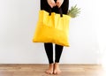 Girl with a shopping bag in yellow hands with.products. Take away, fitness food