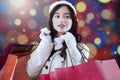 Girl with shopping bags and defocused background Royalty Free Stock Photo