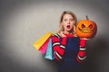 Girl with shopping bags and halloween pumpkin Royalty Free Stock Photo