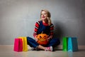 Girl with shopping bags and Halloween pumpkin Royalty Free Stock Photo