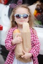 Girl with a shopping cart full of groceries near the car Royalty Free Stock Photo