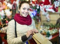 Girl shopping at festive fair before Xmas in evening time