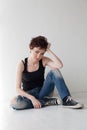 The girl with the short hair sitting on the floor Royalty Free Stock Photo