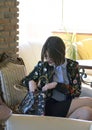 A girl with shorter hair in a flower jacket, a shirt and a skirt. A business styling.