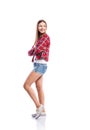 Girl in shorts and checked shirt, arms crossed, isolated Royalty Free Stock Photo