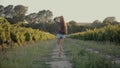 Girl in shorts and shirt walking on the vineyards