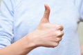 Girl`s show thumb up sign. Human body part positive gesture