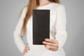 Girl showing blank black flyer brochure booklet. Leaflet present