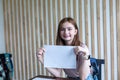 Girl is showing blank paper in the Classroom. ack to school! Royalty Free Stock Photo