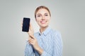 Girl showing cell phone with empty copy space. Happy woman with smartphone. Presenting your product Royalty Free Stock Photo