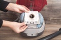 Girl showing dust bag in a vacuum cleaner Royalty Free Stock Photo