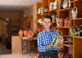 Girl showing finished ceramic production