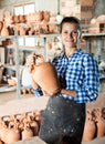 Girl showing finished ceramic production