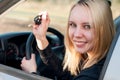 Girl showing key from her new car Royalty Free Stock Photo