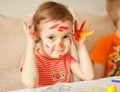 Girl showing painted hands. Hands painted in colorful paints. Education, school, art and painitng concept