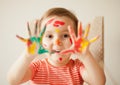 Girl showing painted hands. Hands painted in colorful paints. Education, school, art and painitng concept Royalty Free Stock Photo