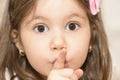 Girl showing silence gesture looking at the camera Royalty Free Stock Photo