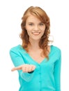 Girl showing something on the palm of her hand Royalty Free Stock Photo