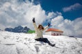 Girl showing victory sign at snow covered mountain top Royalty Free Stock Photo