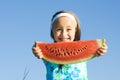 Girl showing a watermelon slice Royalty Free Stock Photo