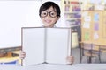 Girl shows an empty page book in class