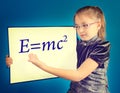 The girl shows the formula written on a plastic board Royalty Free Stock Photo