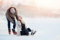 Girl shows guy where she has pain after fall injury on ice skating rink in winter