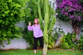 Girl shows hands from behind a tall cactus Royalty Free Stock Photo