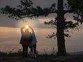 Girl shows love Beautiful view of Pha nok aen cliff in early morning sunrise. Very beautiful light and blue sky with sea of fog fo Royalty Free Stock Photo